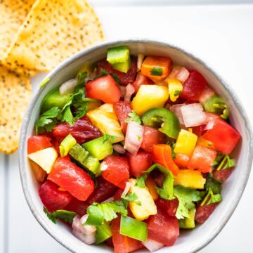 overhead image of pineapple salsa in a small bowl with chips on the side