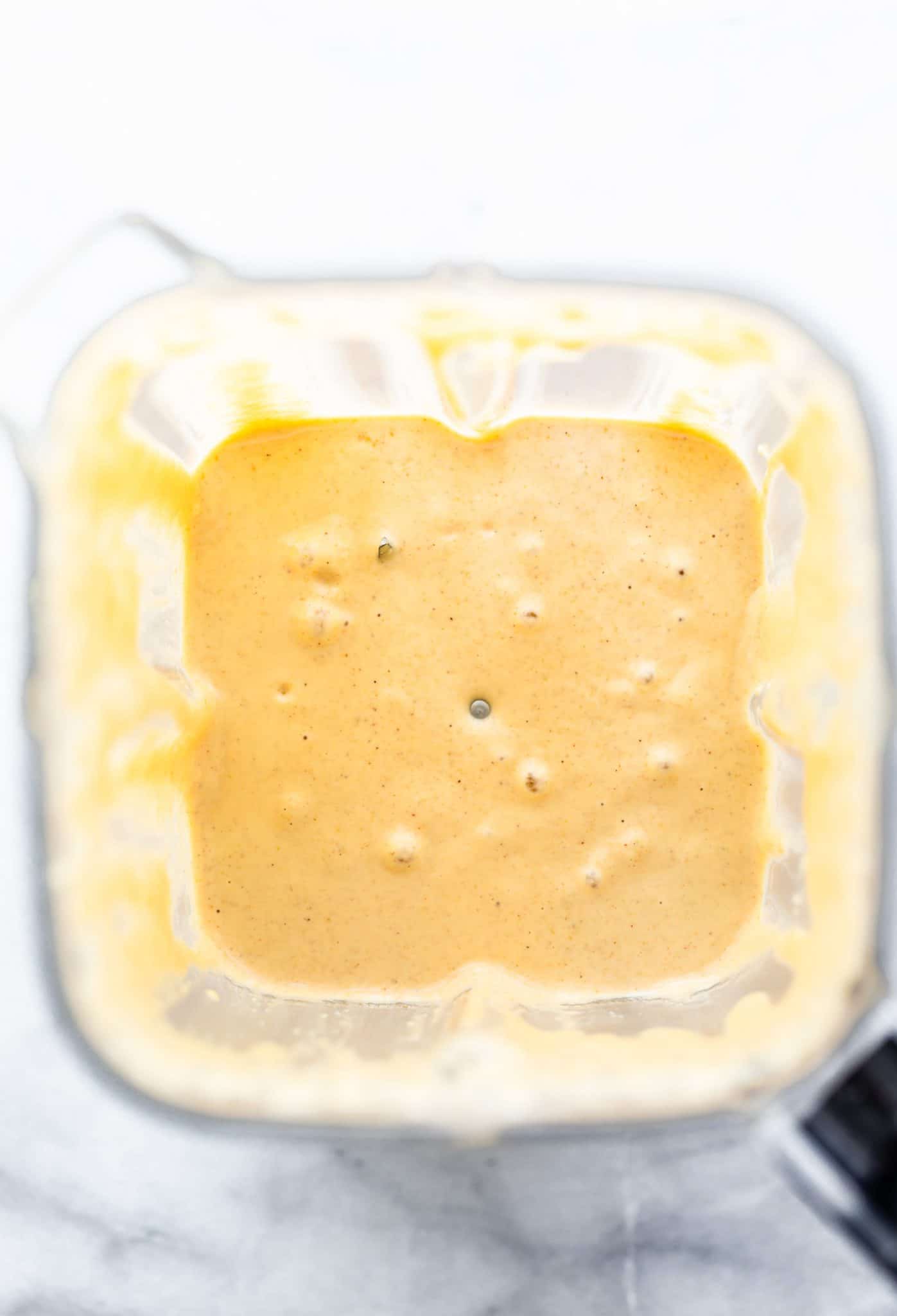 Overhead image of peanut butter waffle batter in a blender.