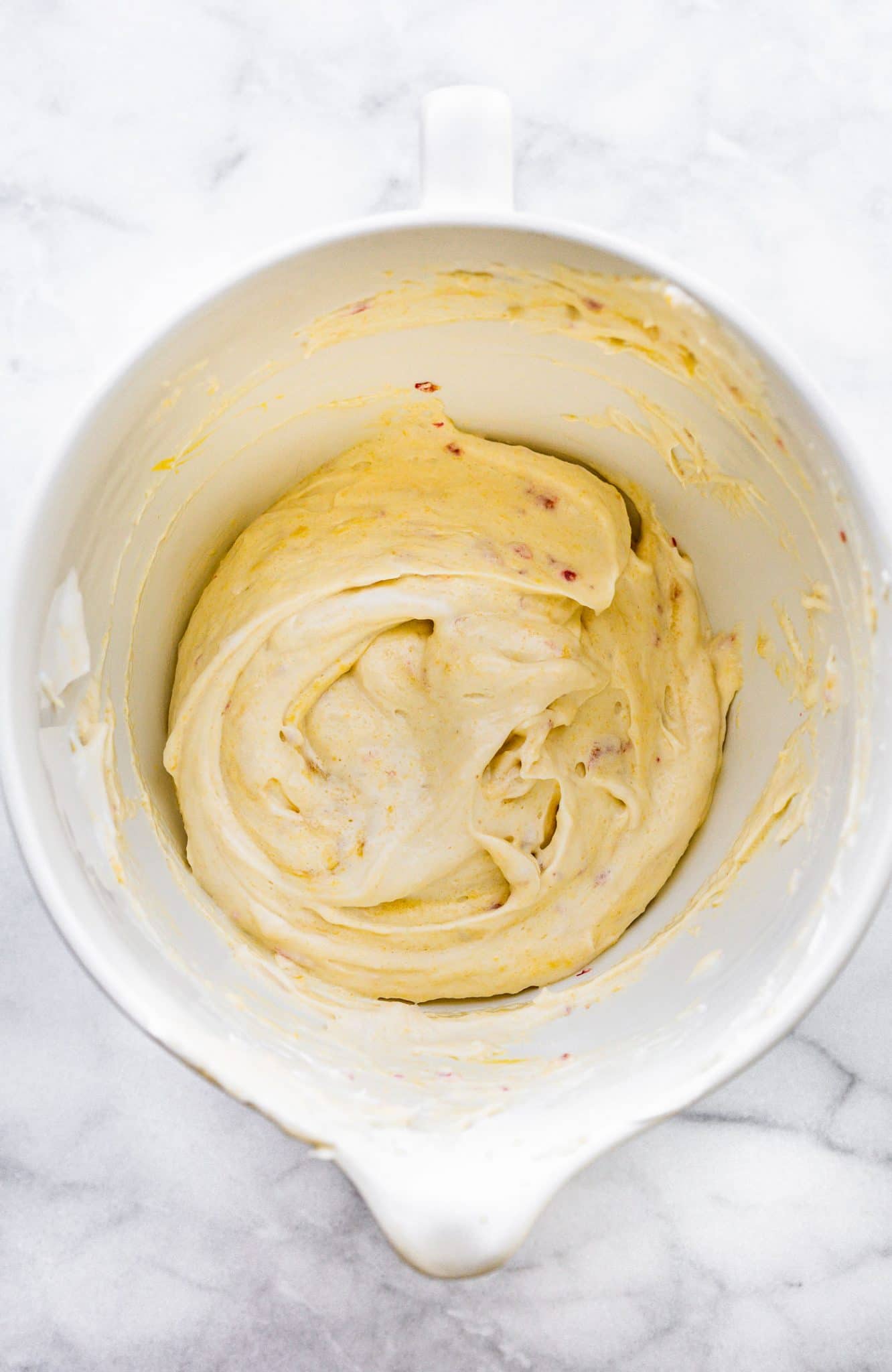 Overhead image of berry almond cake batter in a bowl.