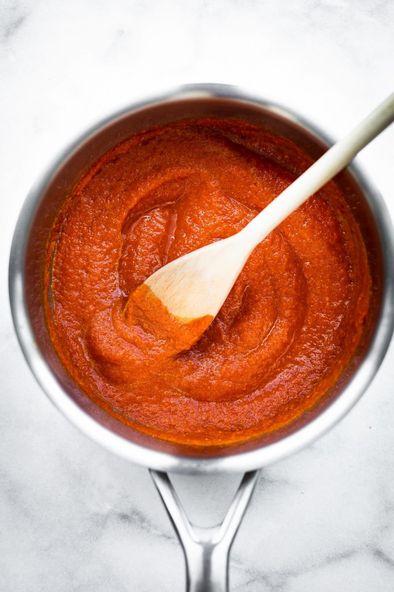 Overhead image of homemade sriracha being cooked in a sauce pot.