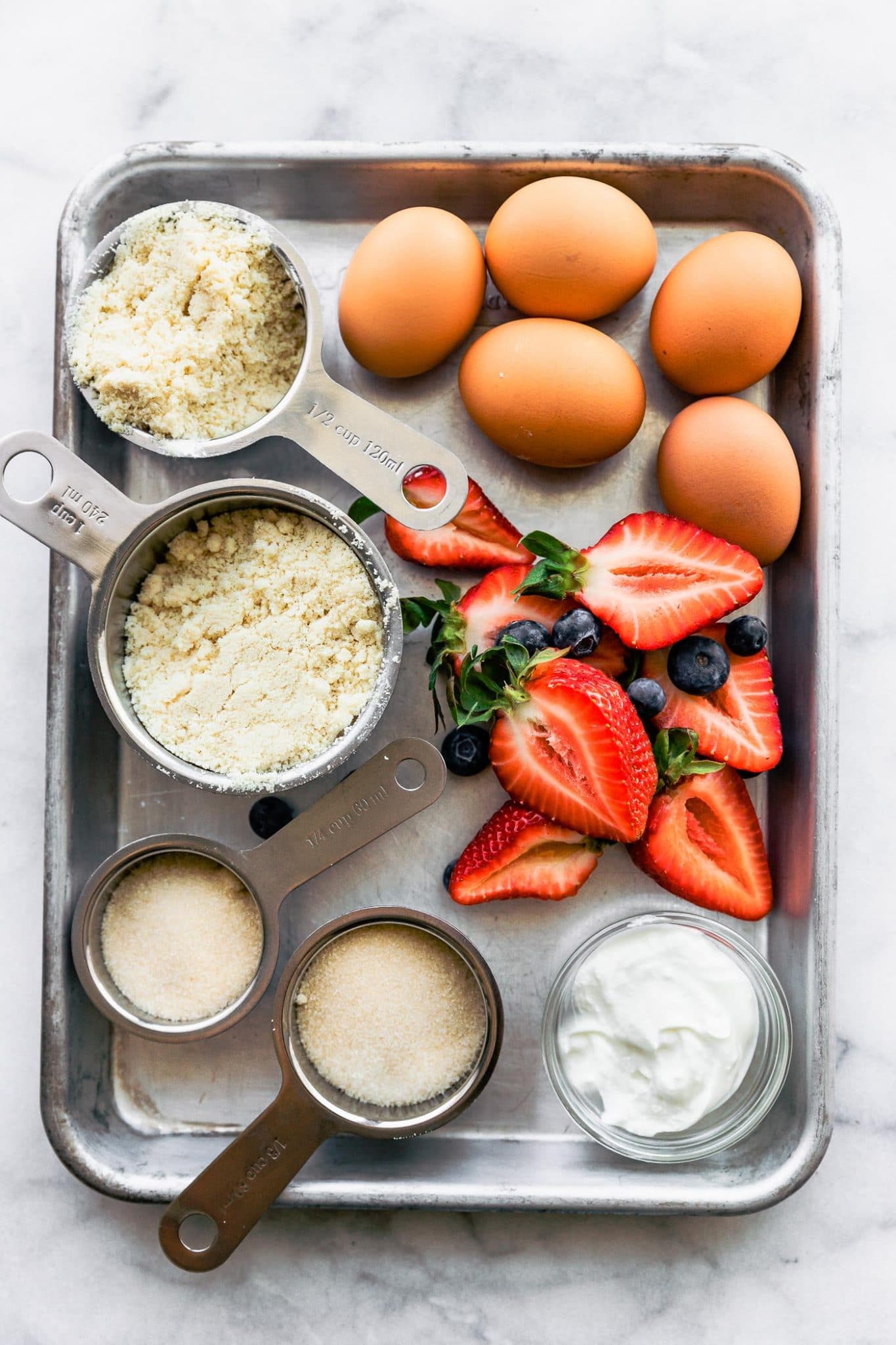 Overhead image of ingredients for almond cake with yogurt frosting.