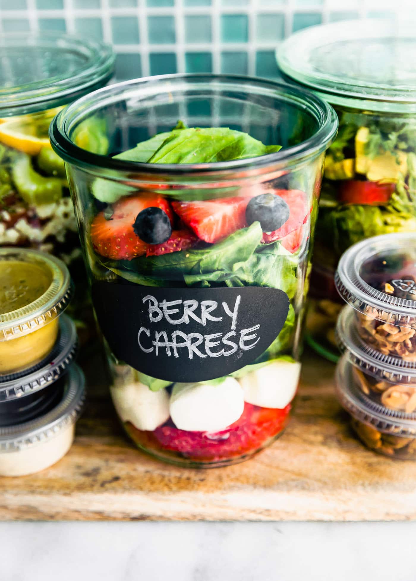 Close up image of berry caprese salad in a mason jar