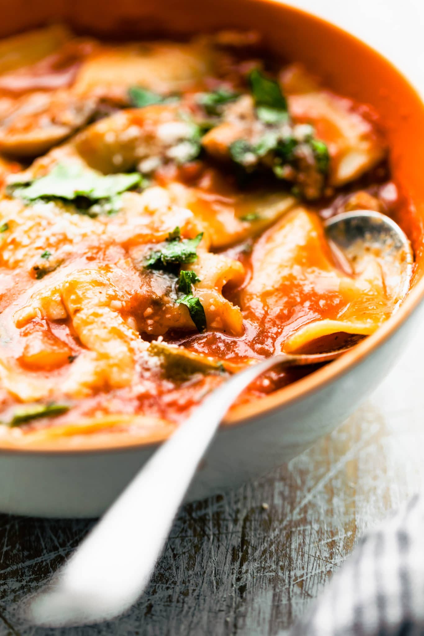 Close up image of gluten free lasagna noodle soup in a bowl with a spoon