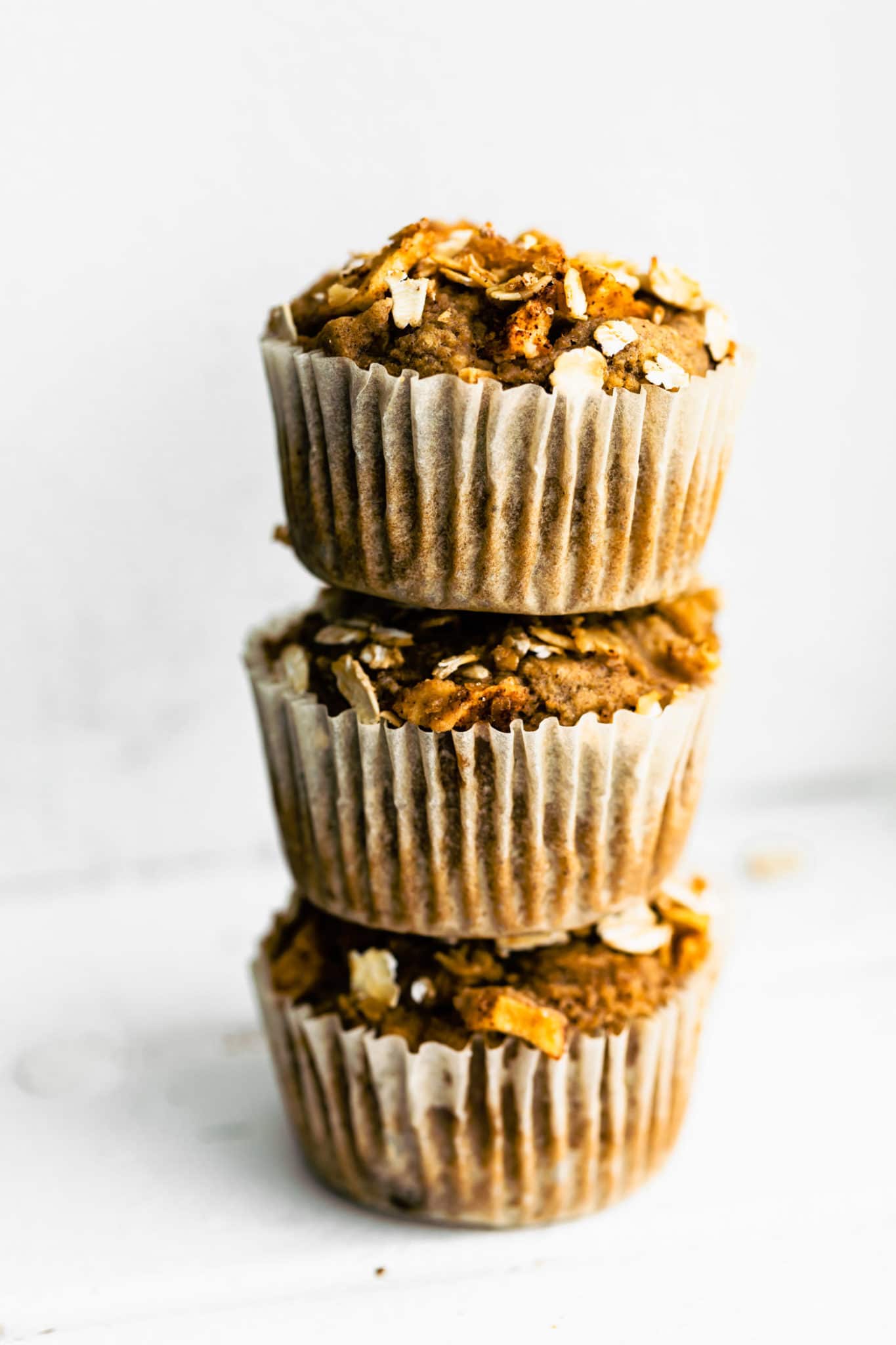 3 gluten free apple oatmeal muffins stacked on top of each other