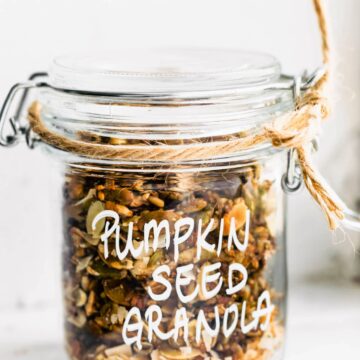 pumpkin seed granola in a jar with twine wrapped around the top