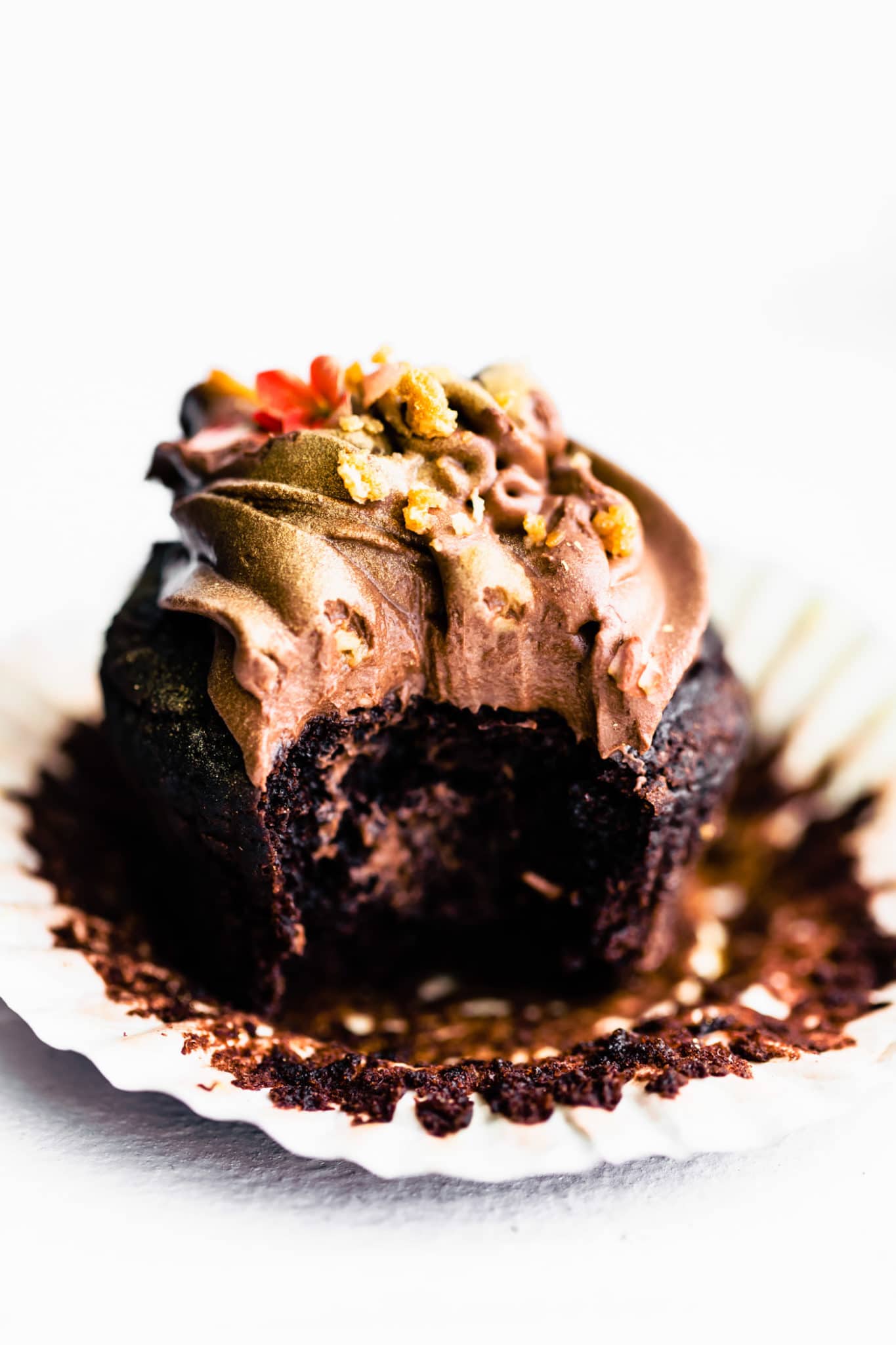 egg free chocolate cupcake with chocolate frosting with a bite taken out of the side