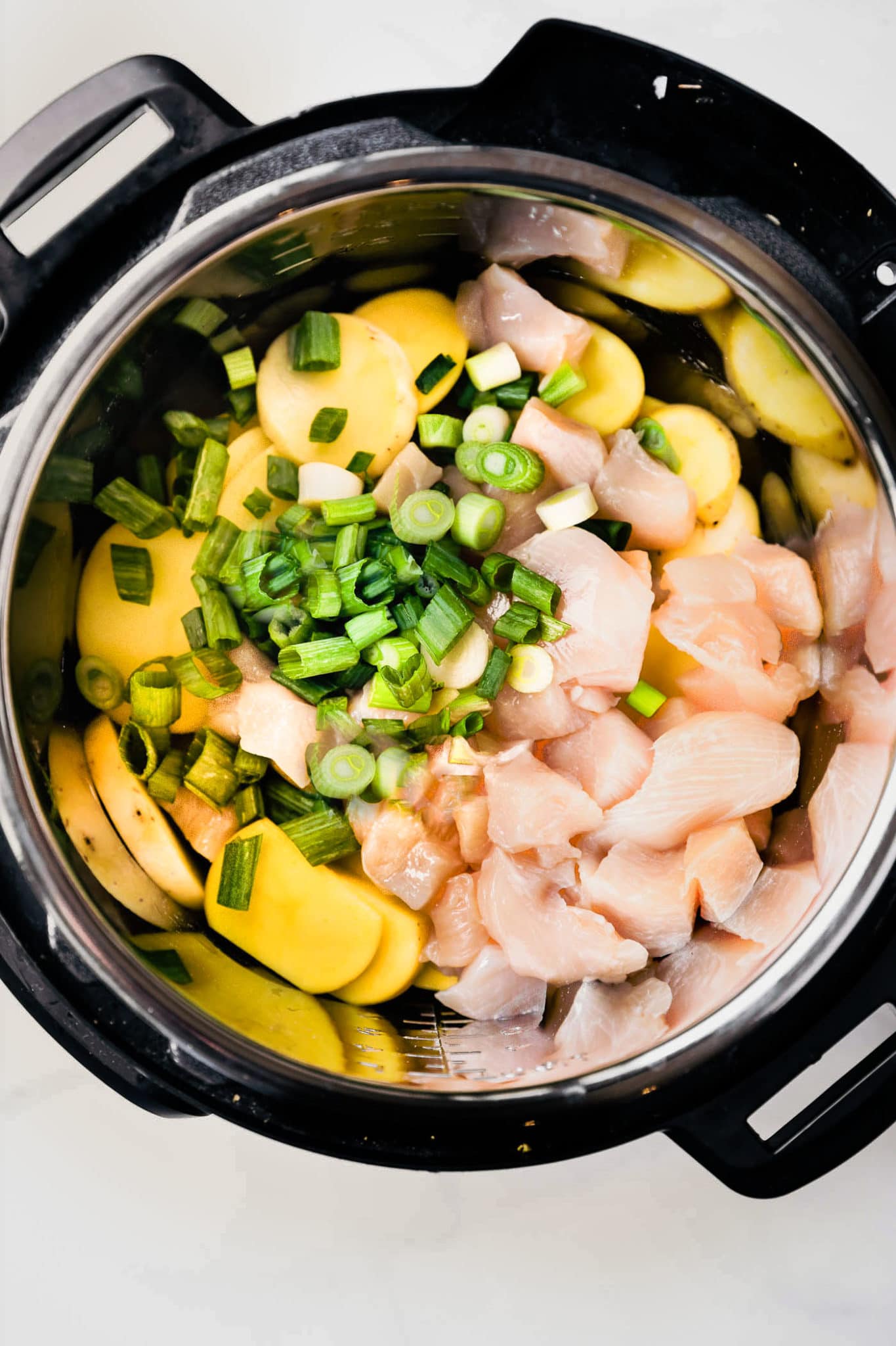 Chicken, potatoes, and scallions in an instant pot