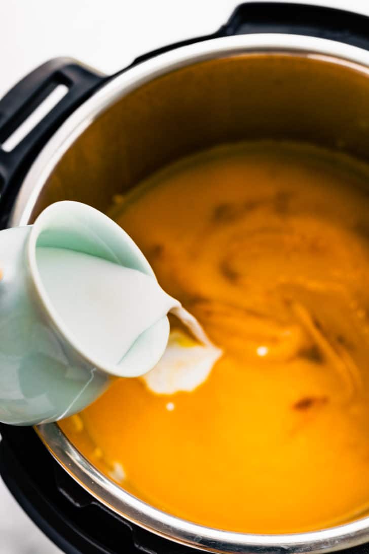 pouring cream into instant pot soup mix