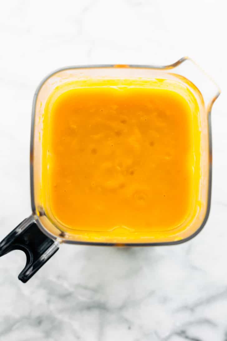 Pureed butternut squash soup in a blender