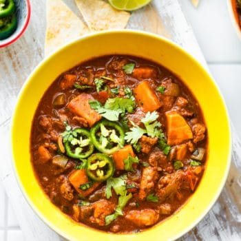 sweet potato turkey chili in a bowl topped with cilantro and jalapeno