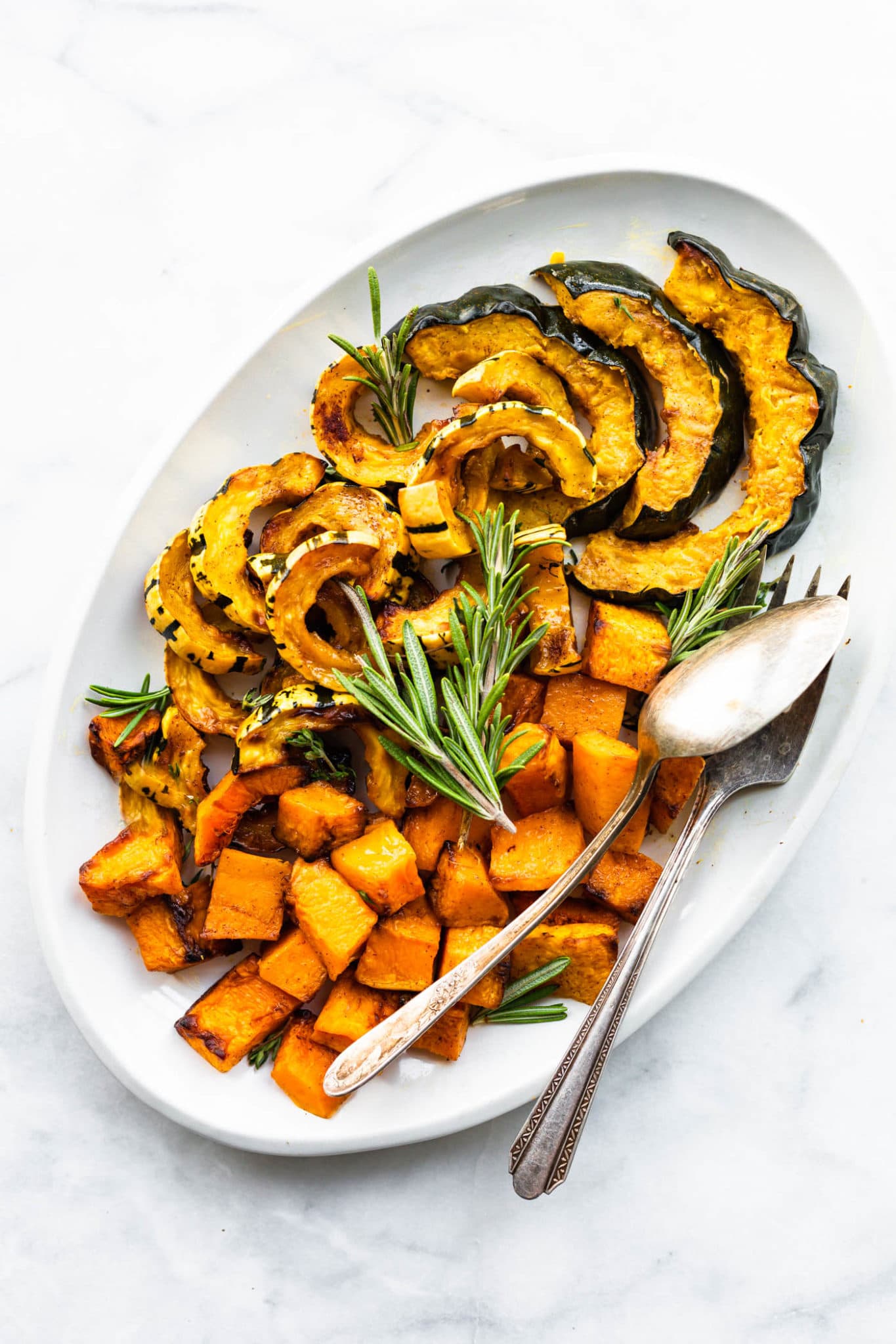 Roasted acorn, delicata, and butternut squash on a serving platter