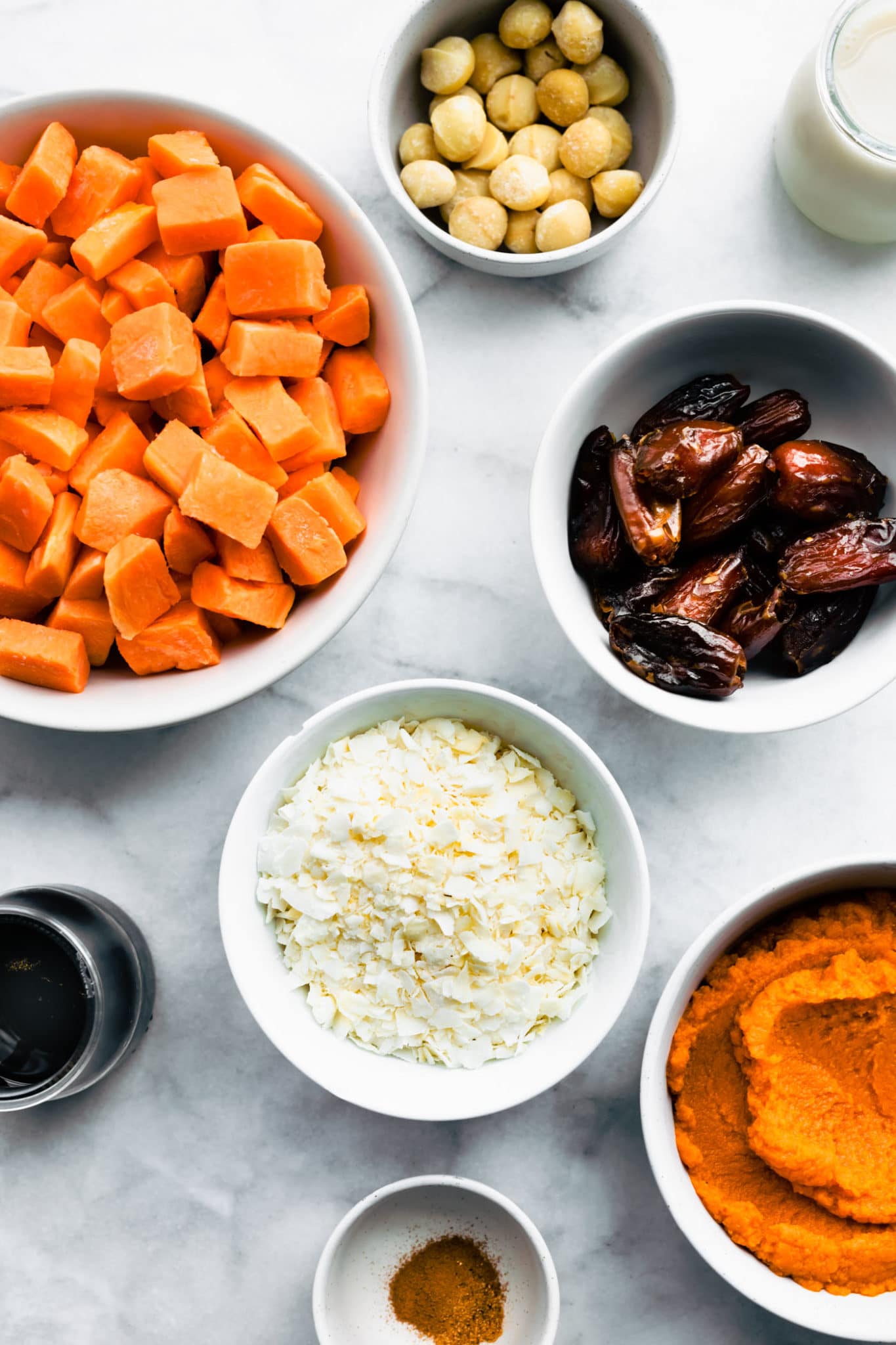 Ingredients for vegan sweet potato casserole in small white bowls
