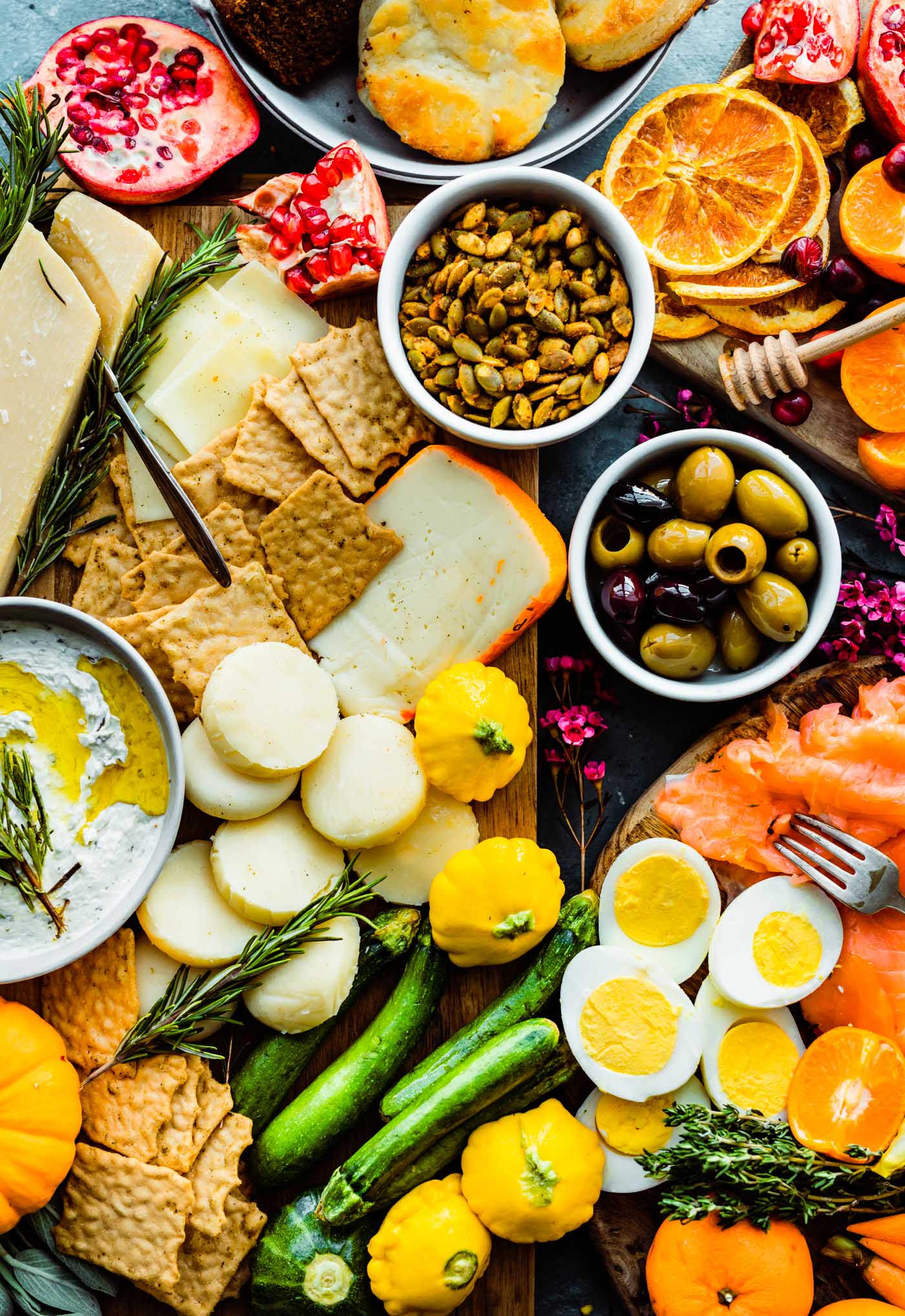 overhead image of grazing table with cheese, nuts, fruit, and more