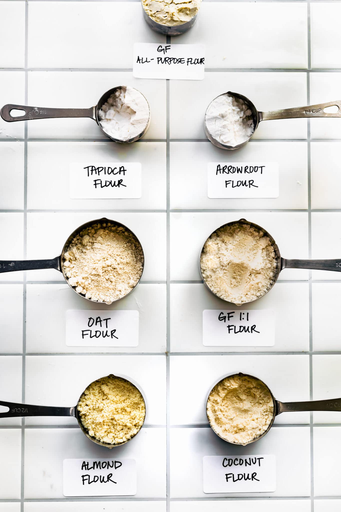 Gluten free flour alternatives in measuring cups labeled