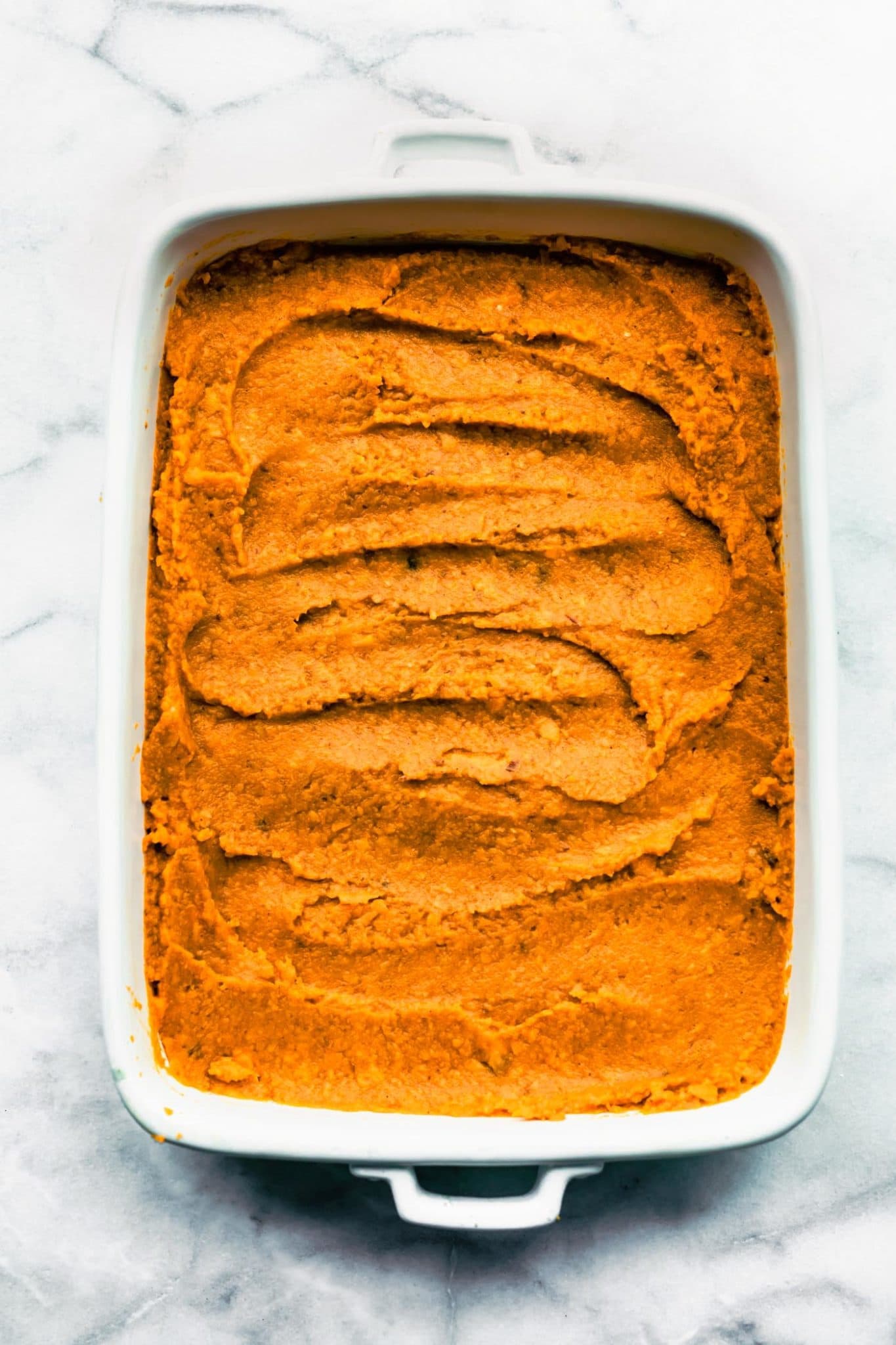 vegan sweet potato casserole in a baking dish without topping