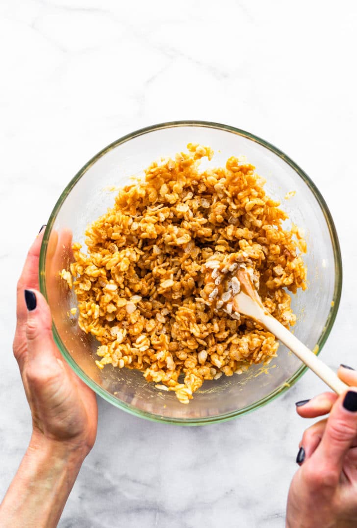 peanut butter rice krispie treats batter in a clear mixing bowl