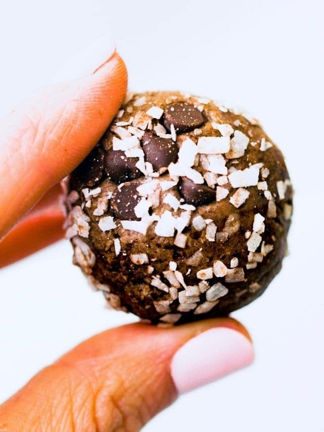 Close up view of chocolate protein coconut balls.