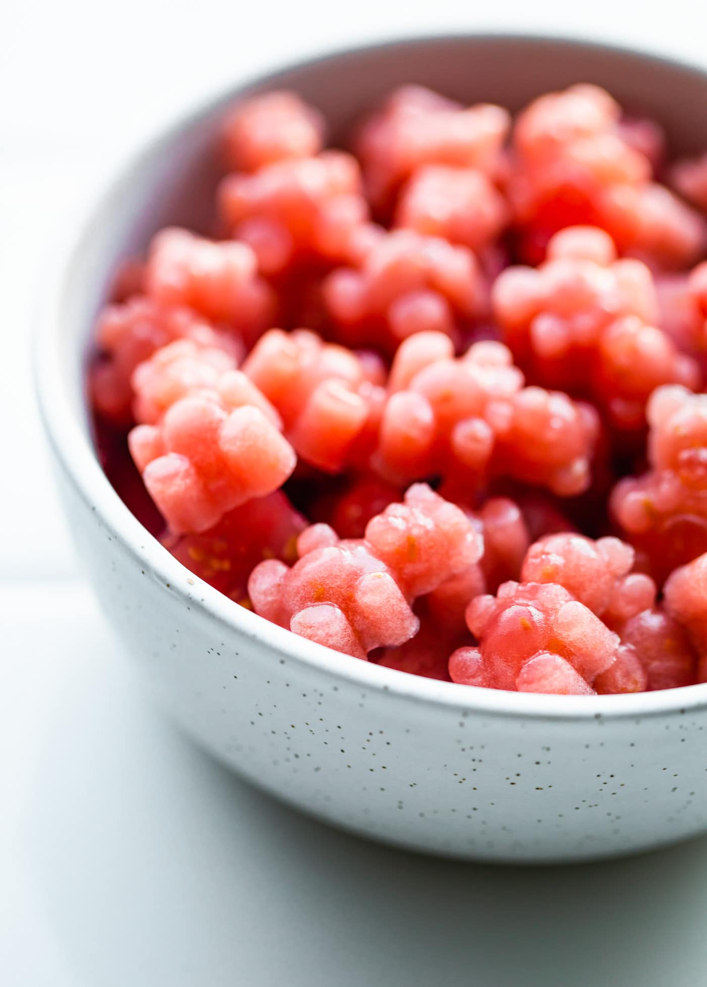 a close up image of a bowl of red homemade gummies with probiotics made in the shape of bears