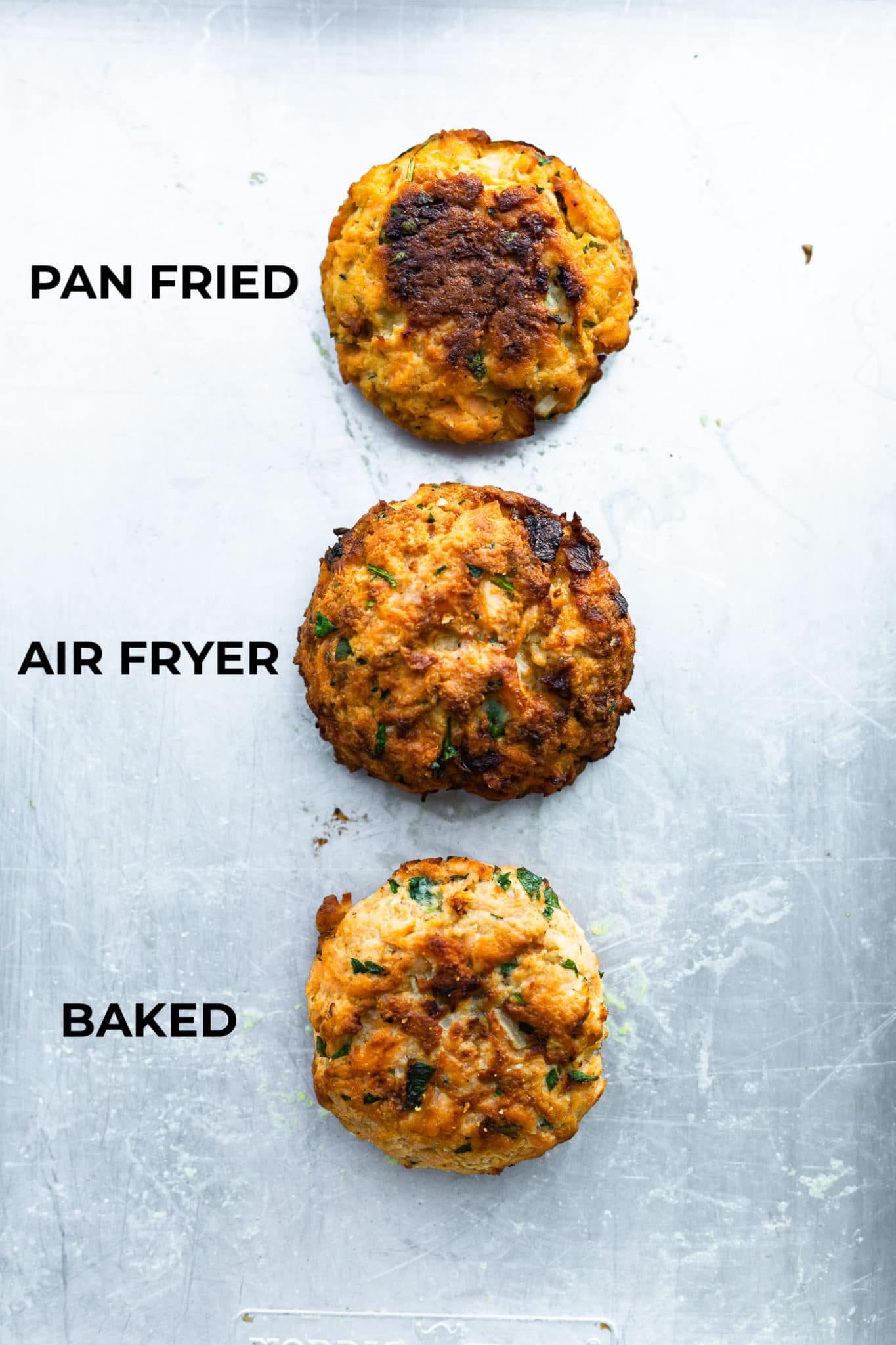 3 salmon cakes one made in the skillet, one made in the air fryer, and one baked