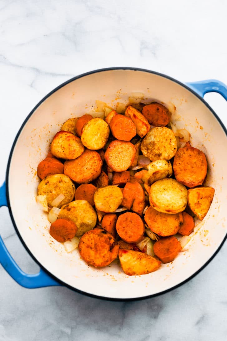 roasted potatoes, carrots, and parsnips in a large pot