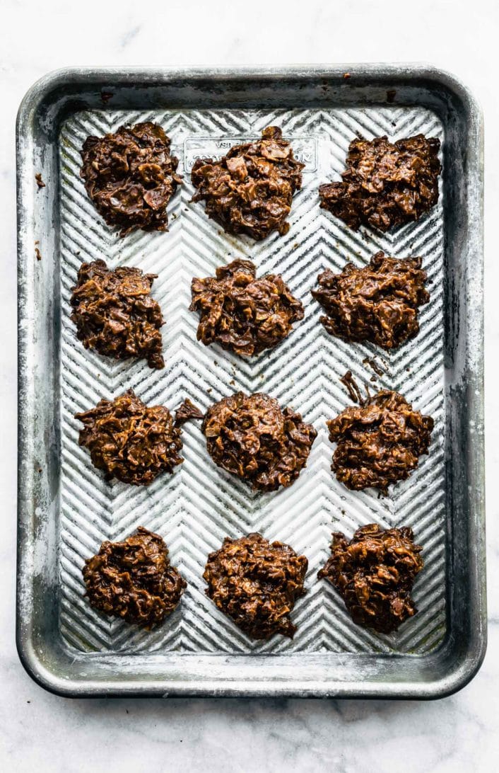 12 no bake chocolate peanut butter cornflake cookies on a baking sheet