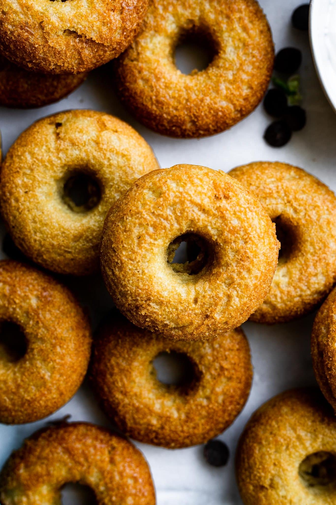 a pile of unglazed baked vegan donuts