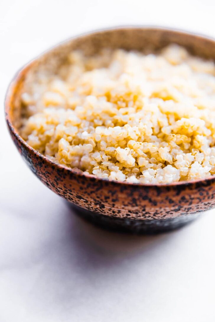 a brown speckled bowl of quinoa