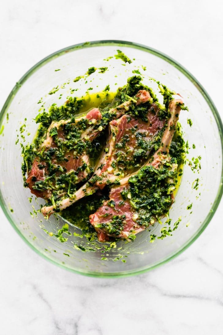 lamb chops in green herb marinade, raw.