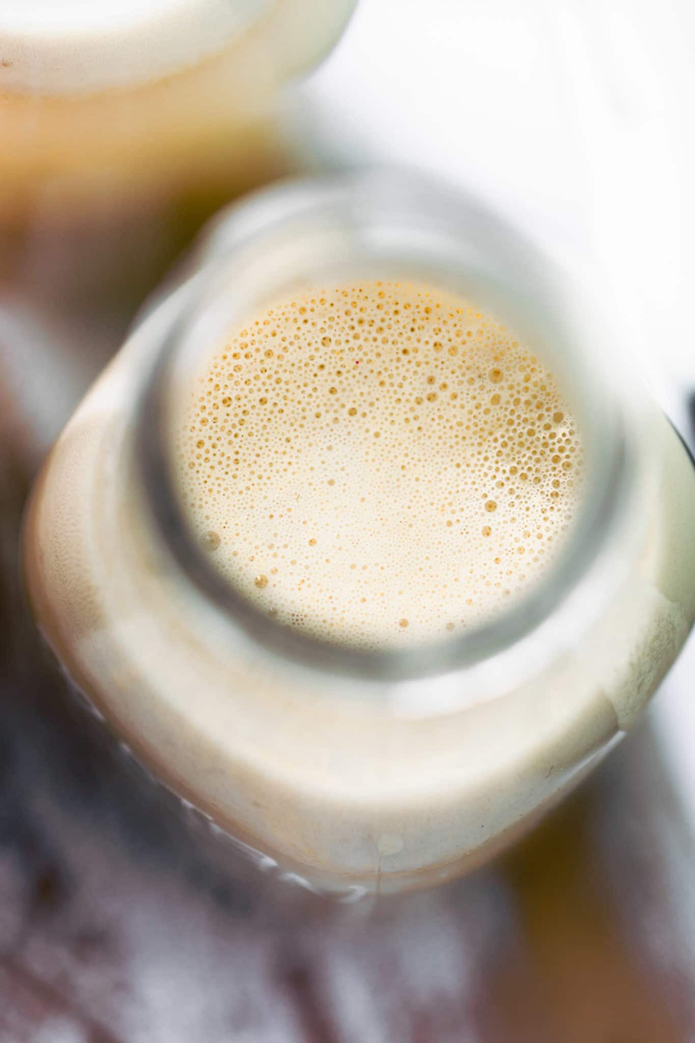 overhead image of oat milk in bottle, close up