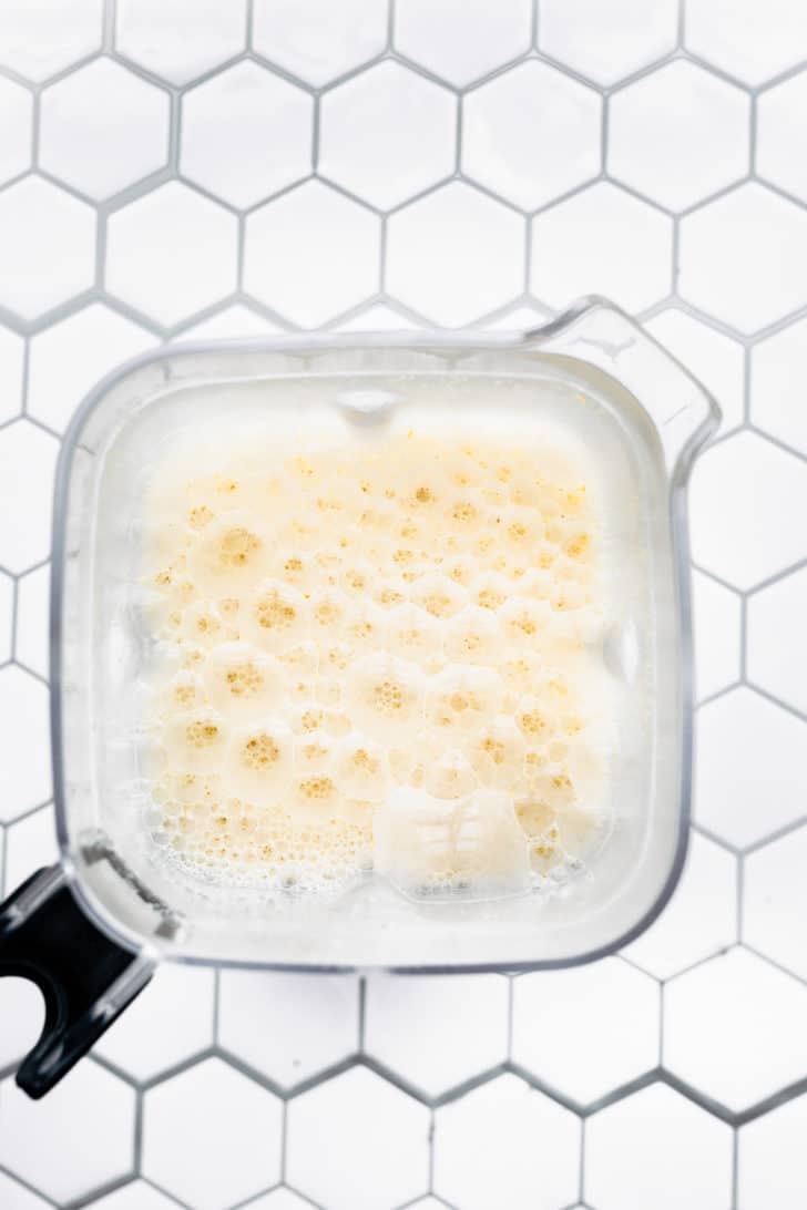 overhead image of homemade oat milk in a blender