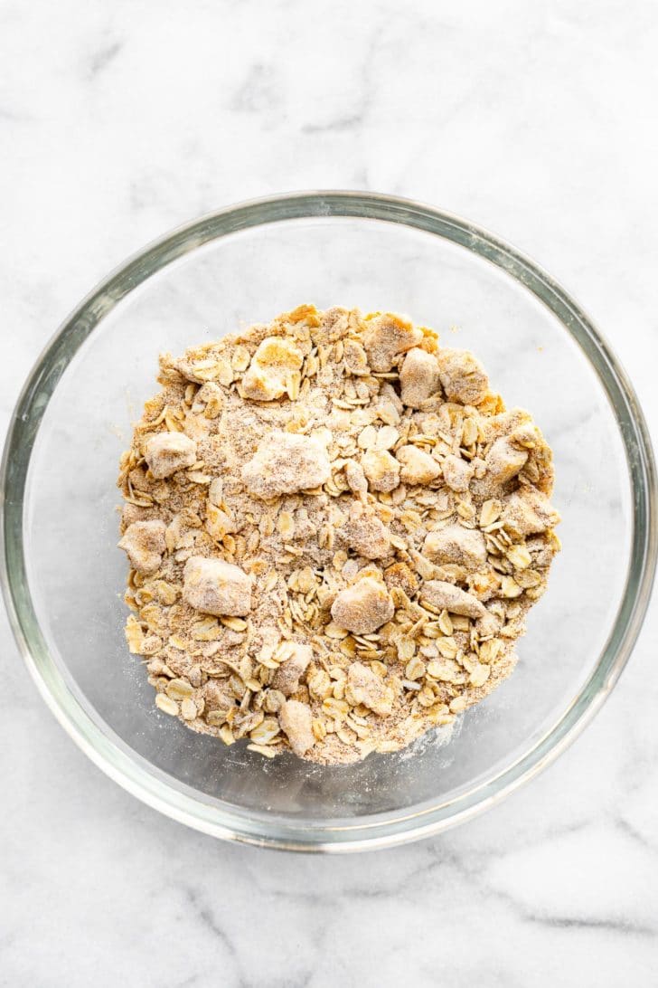 oats, sugar, and vegan butter in a glass bowl to form a crumble
