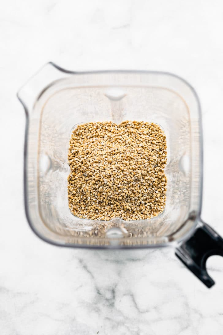 overhead image of quick oats in a blender to make oat flour