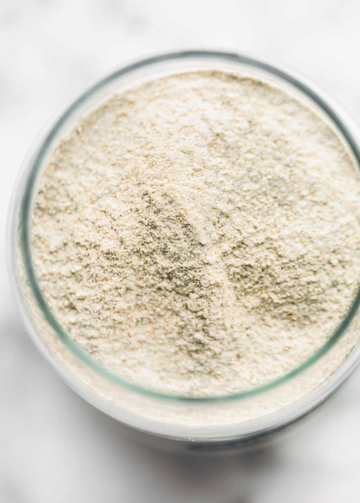 overhead image of homemade buckwheat flour in a glass jar