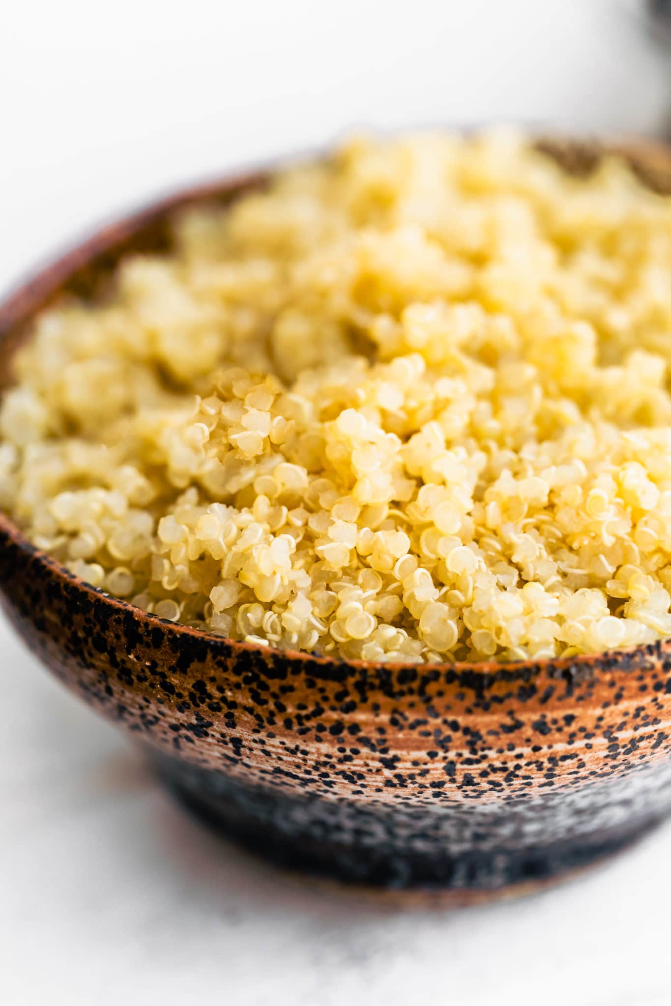 a bowl full of cooked qluten free quinoa grains