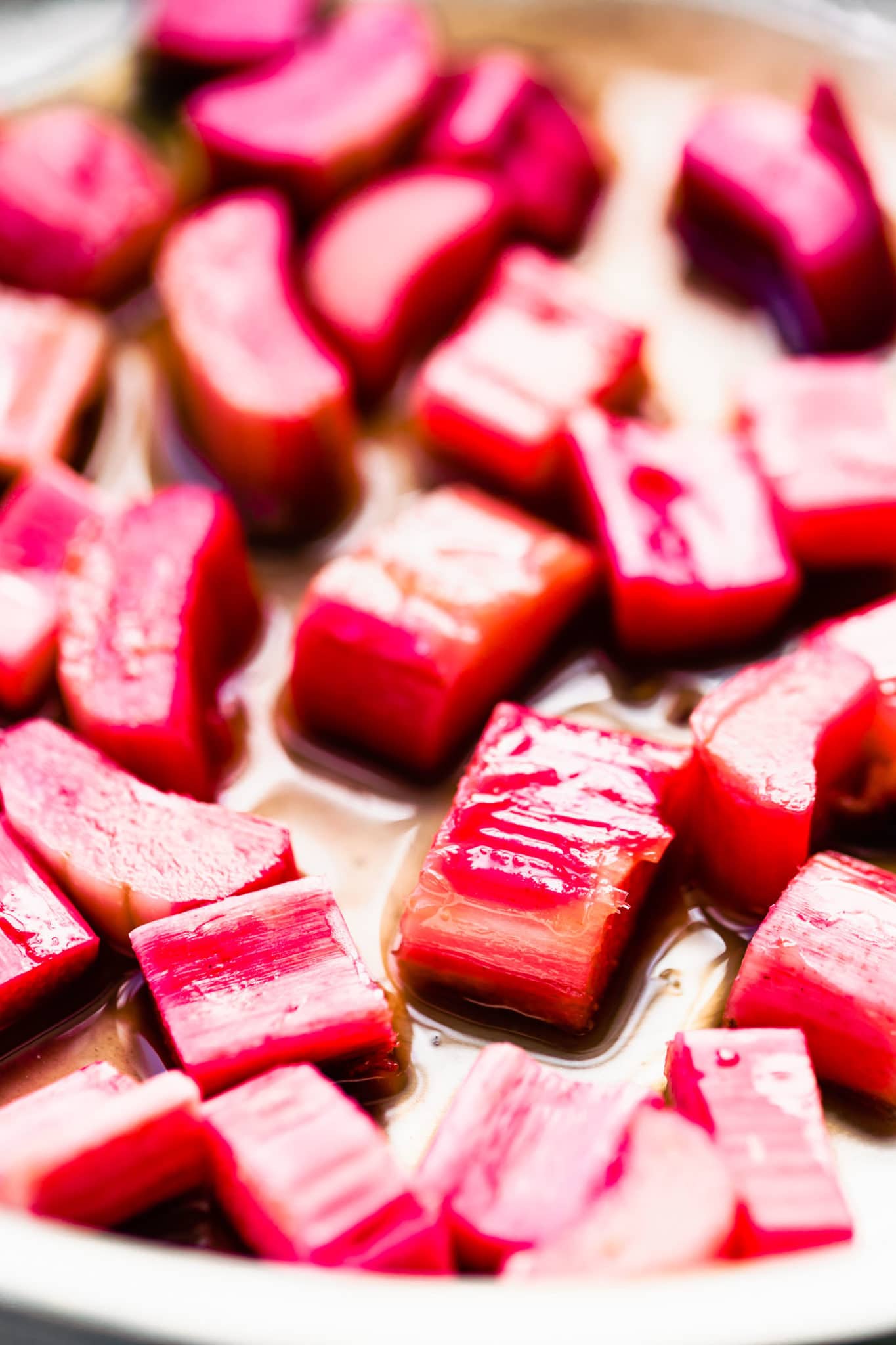 Close up view of fresh diced rhubarb in skillet cooking down.