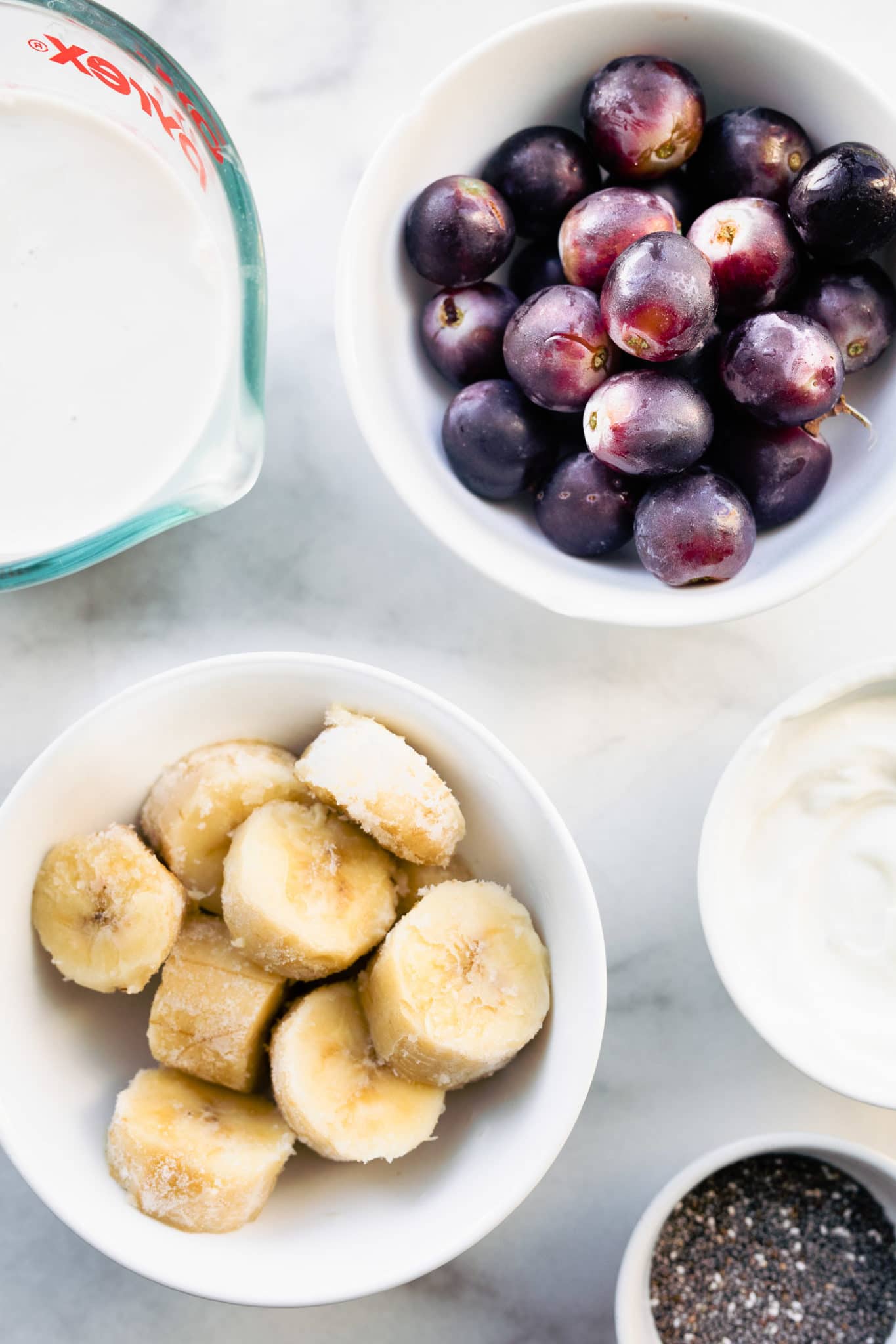 non-dairy milk, frozen grapes, frozen banana slices, non-dairy yogurt, and chia seeds for a frozen grape smoothie recipe