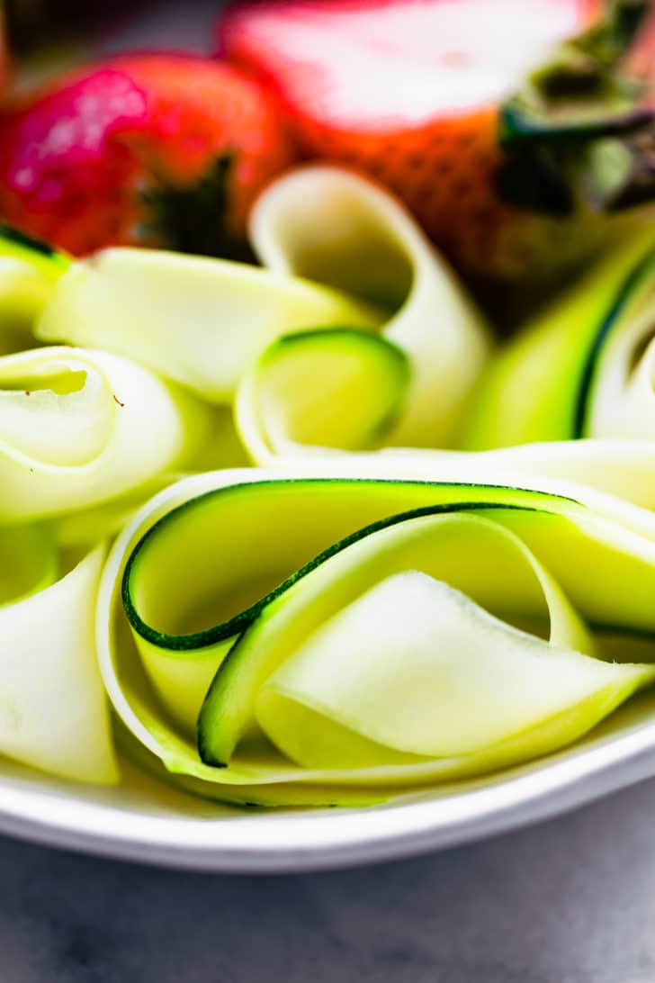 close up image of spiralized zucchini ready to make a summer strawberry salad recipe