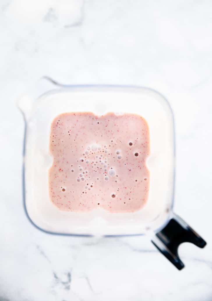 overhead image of a frozen grape smoothie in a blender