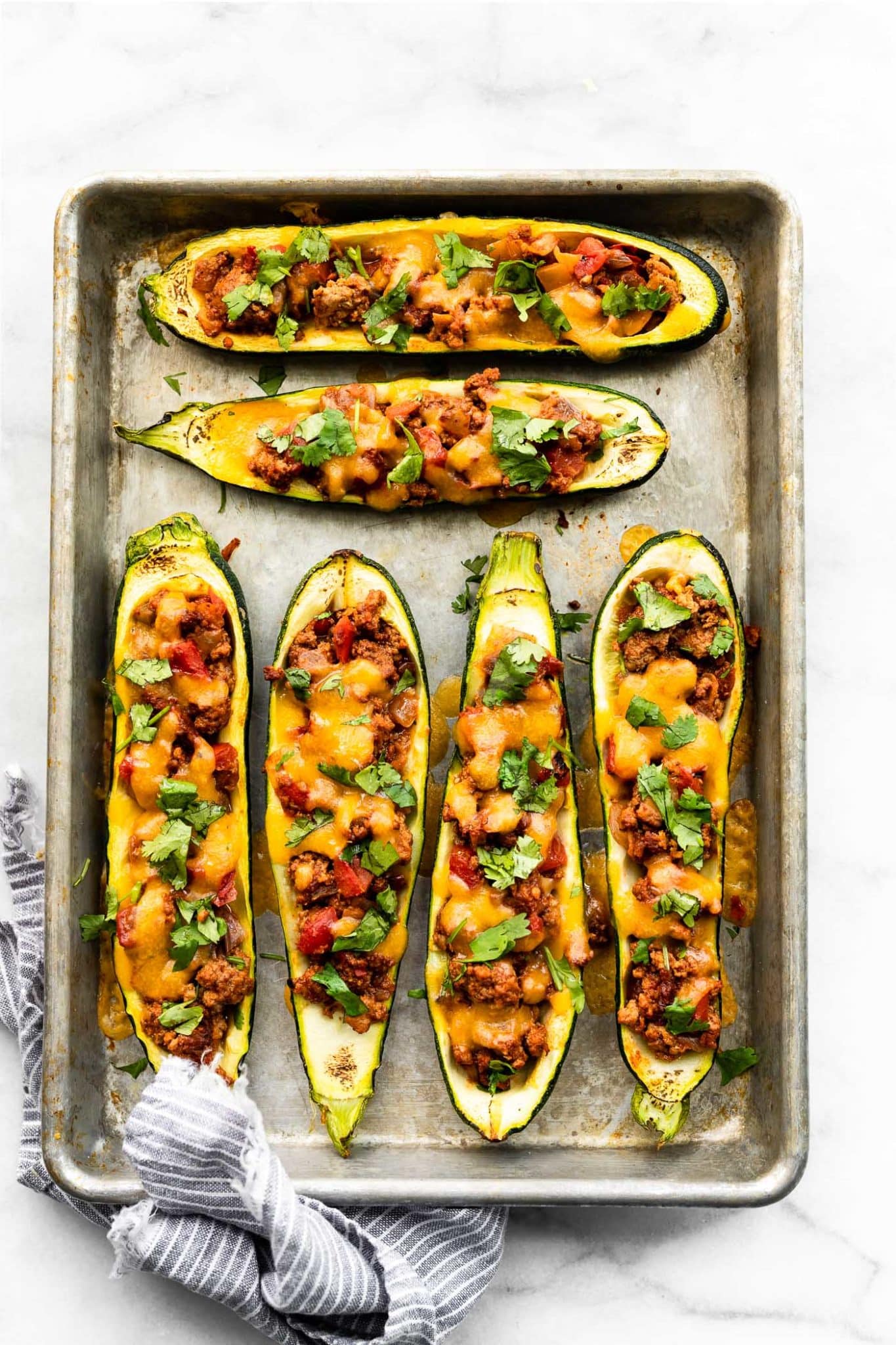 a baking dish full of enchilada stuffed zucchini boats