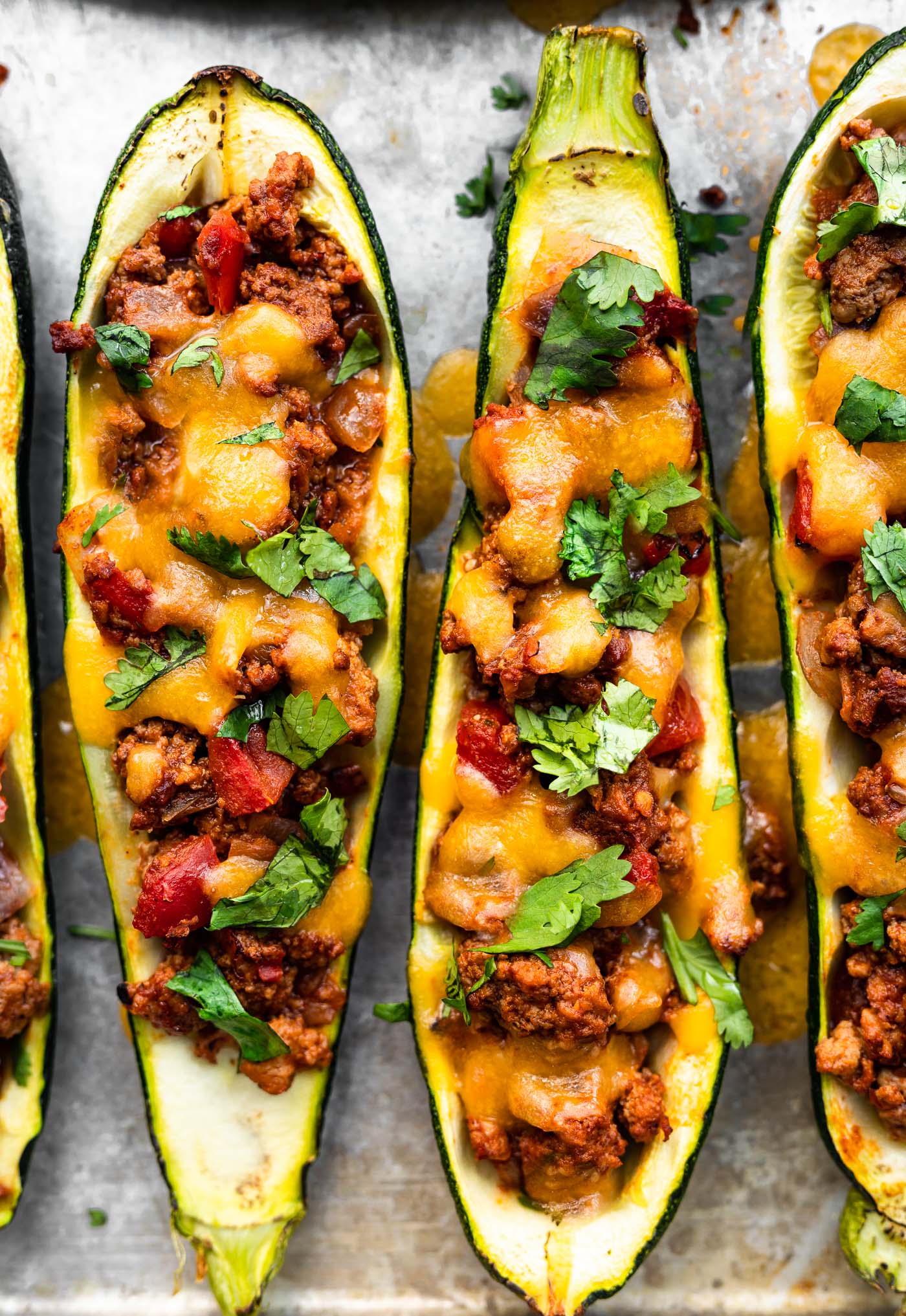 close up image of baked enchilada zucchini boats topped with fresh cilantro