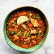 overhead bowl of mexican sweet potato beef stew slow cooker recipe topped with a lime wedge