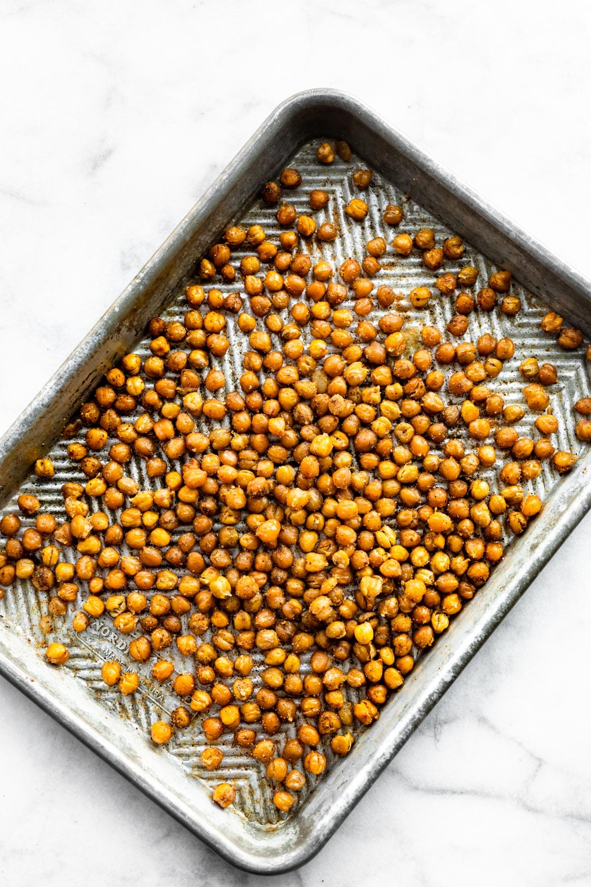a baking sheet full of savory roasted chickpeas