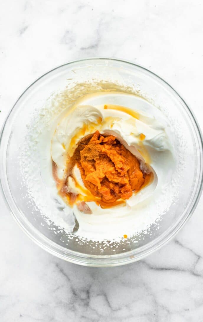coconut cream and pumpkin puree in a glass bowl ready to be combined