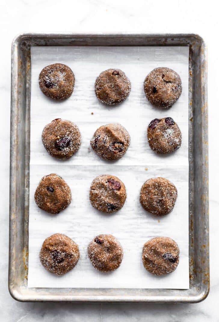 vegan cranberry molasses cookies on a baking sheet