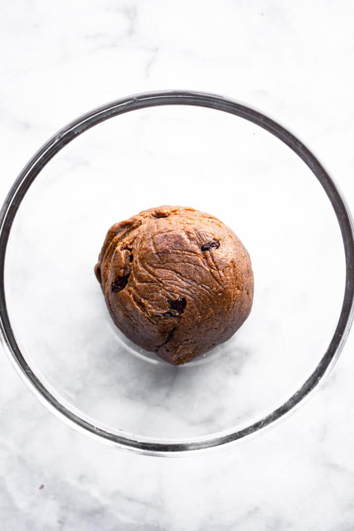 overhead image of vegan molasses cookies dough in a glass bowl