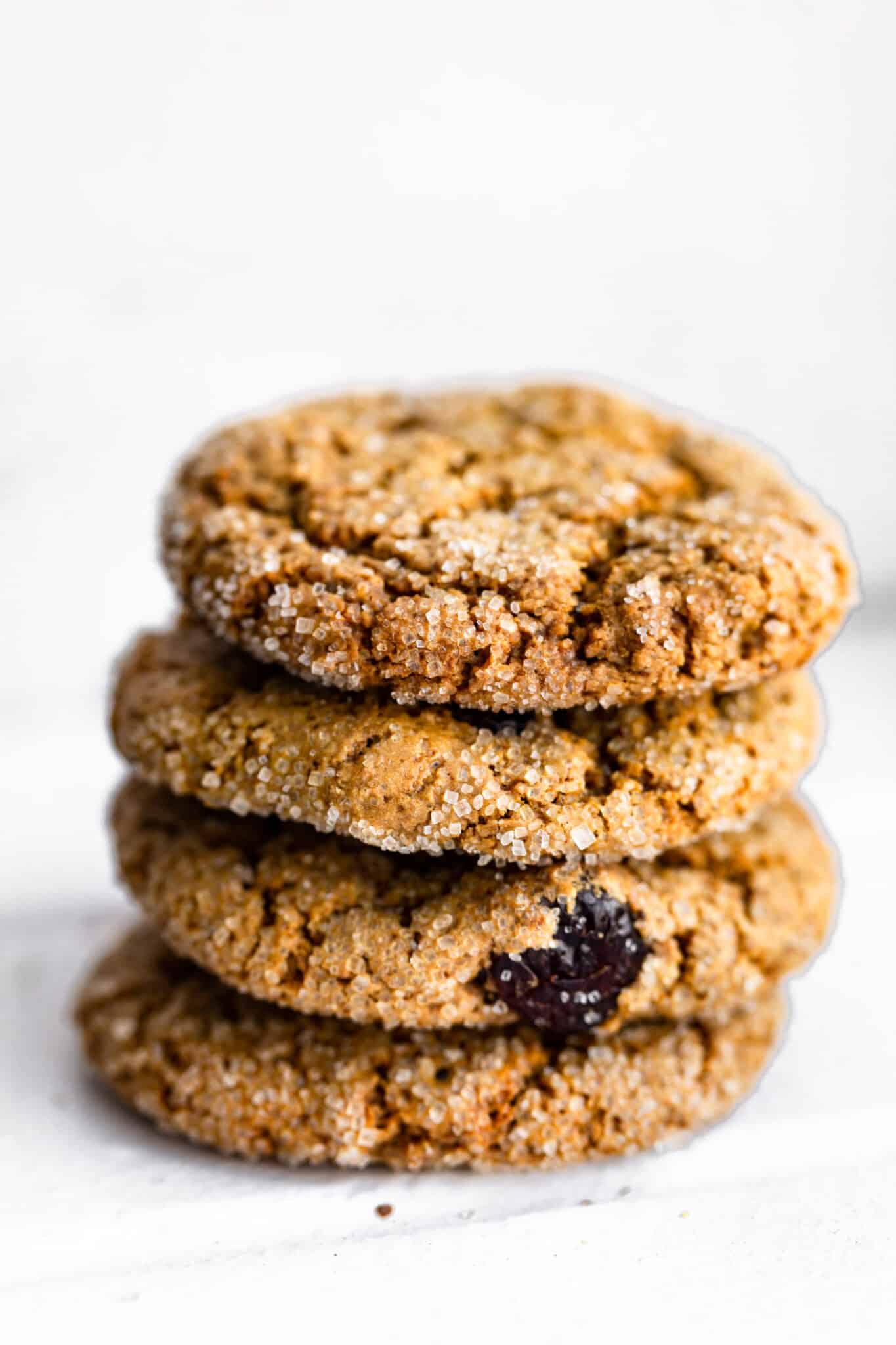 four vegan molasses cookies stacked on top of each other