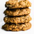stack of almond butter cookies with white backdrop.