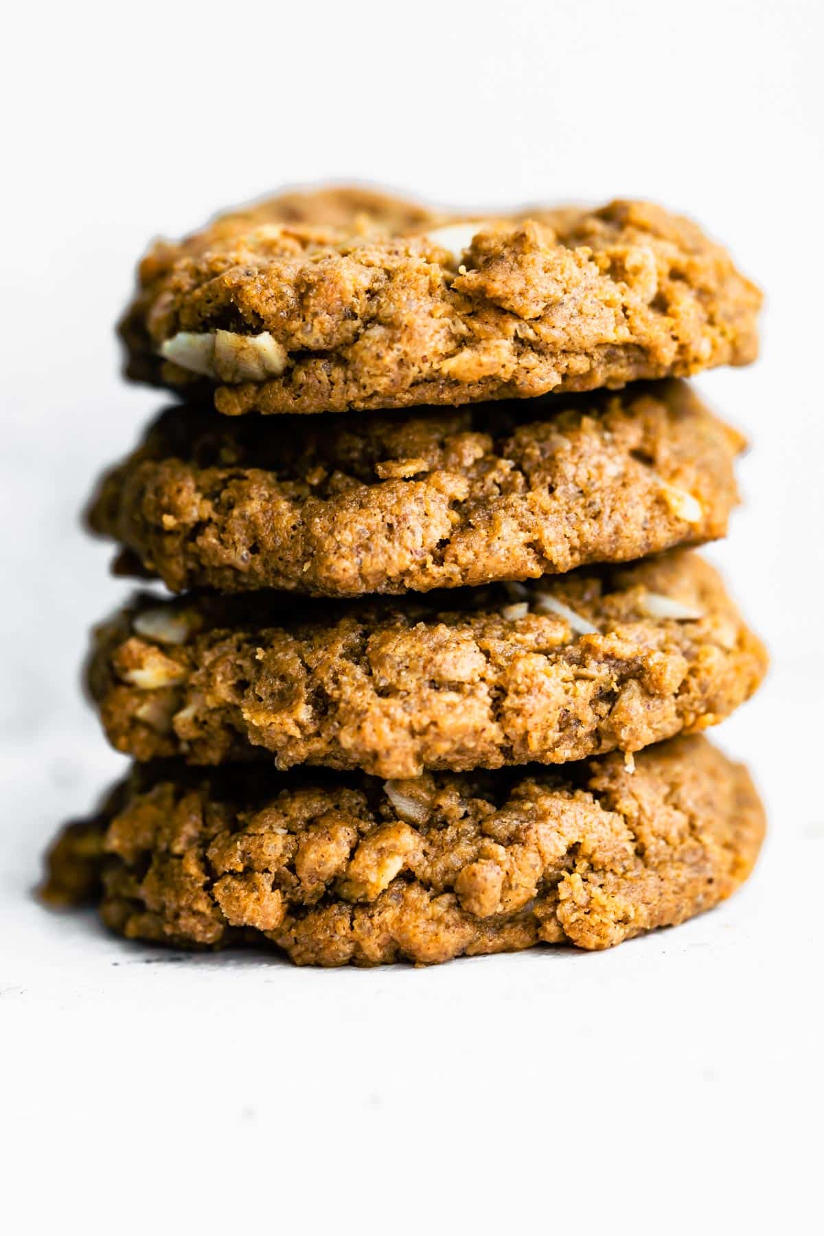 stack of almond butter cookies with white backdrop.