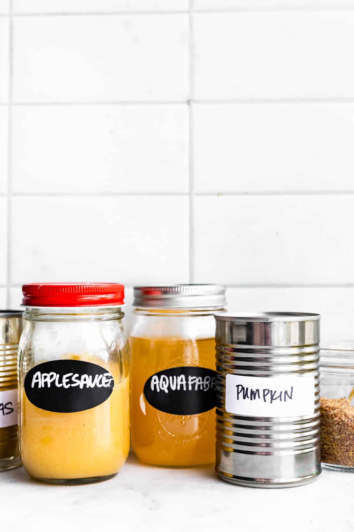 jars of aquafaba, applesauce, and pumpkin for vegan egg replacers