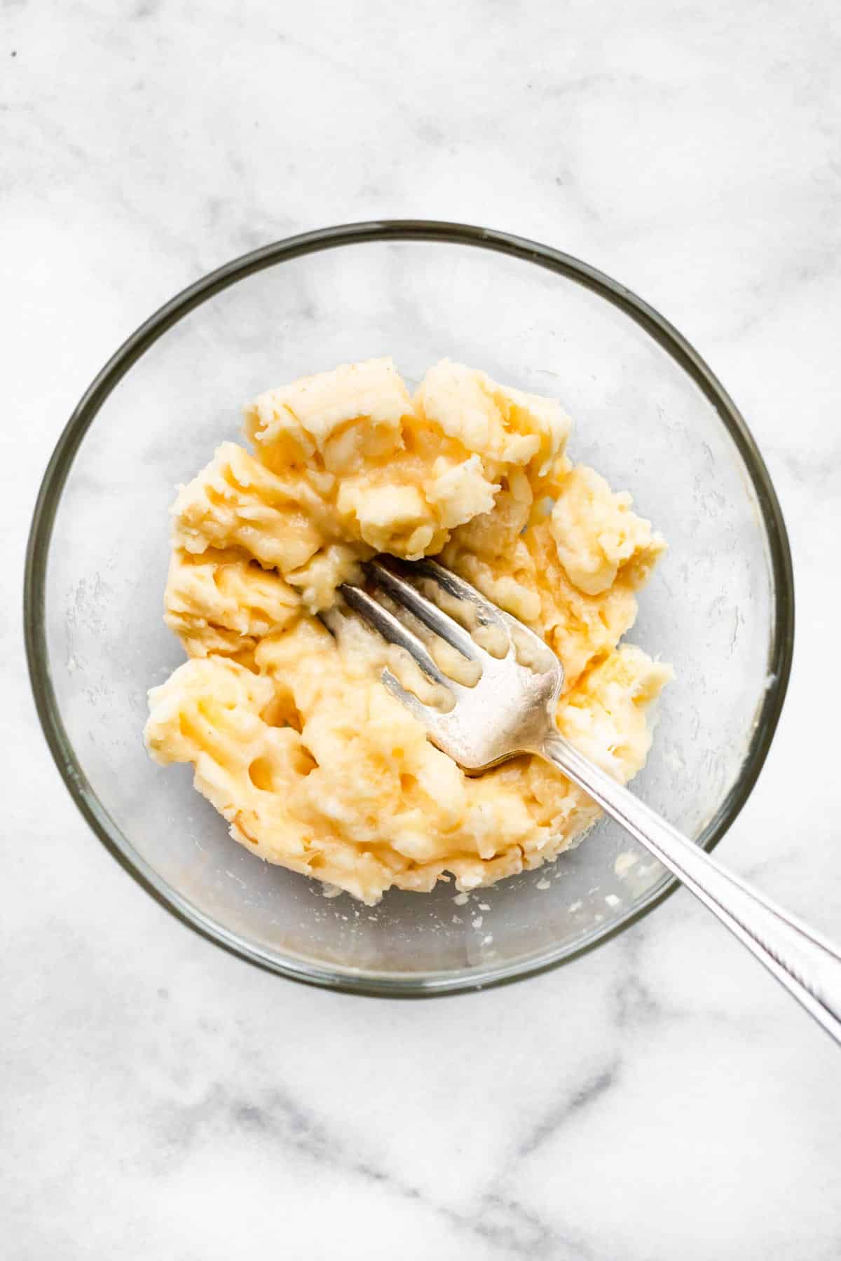 overhead image of mashed banana in a bowl